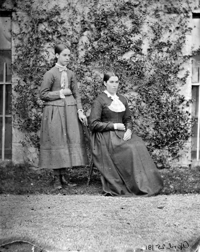 Portrait of two servant girls, identified as Pat Dolan's daughters, at back of Clonbrock House, Co. Galway